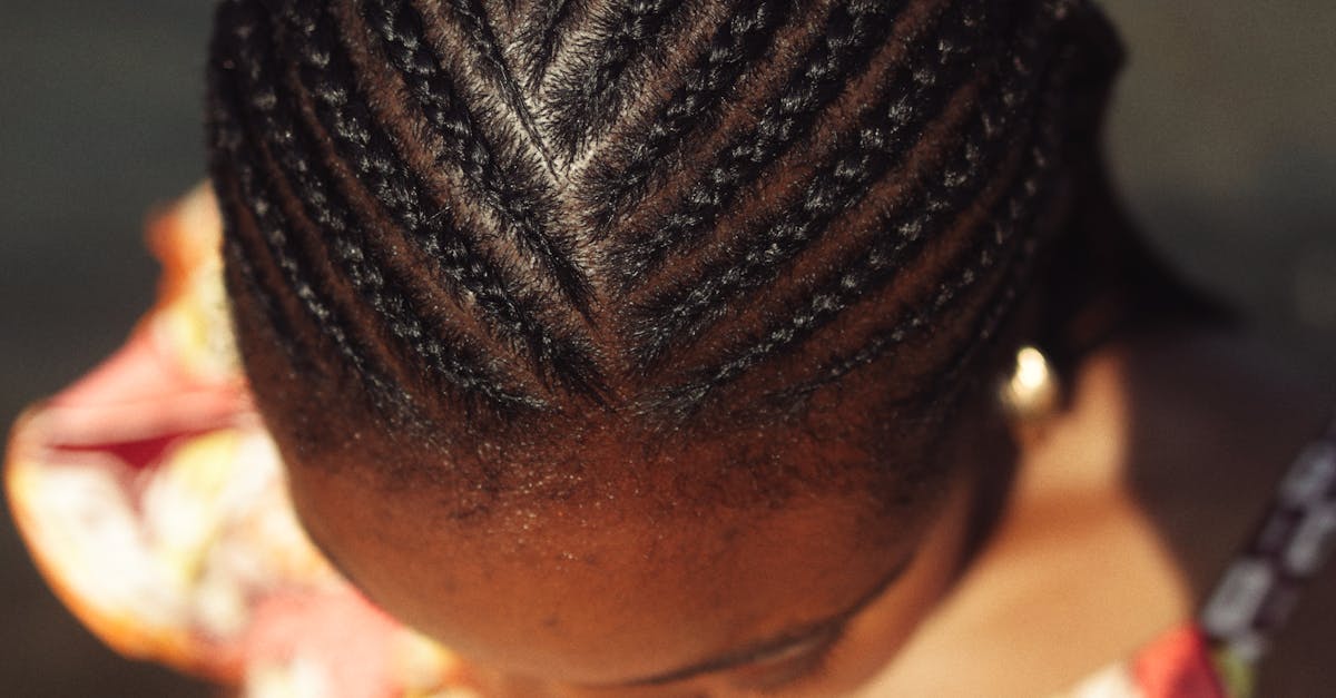 Detailed top view of intricate braided hairstyle on woman's head, showcasing traditional beauty.