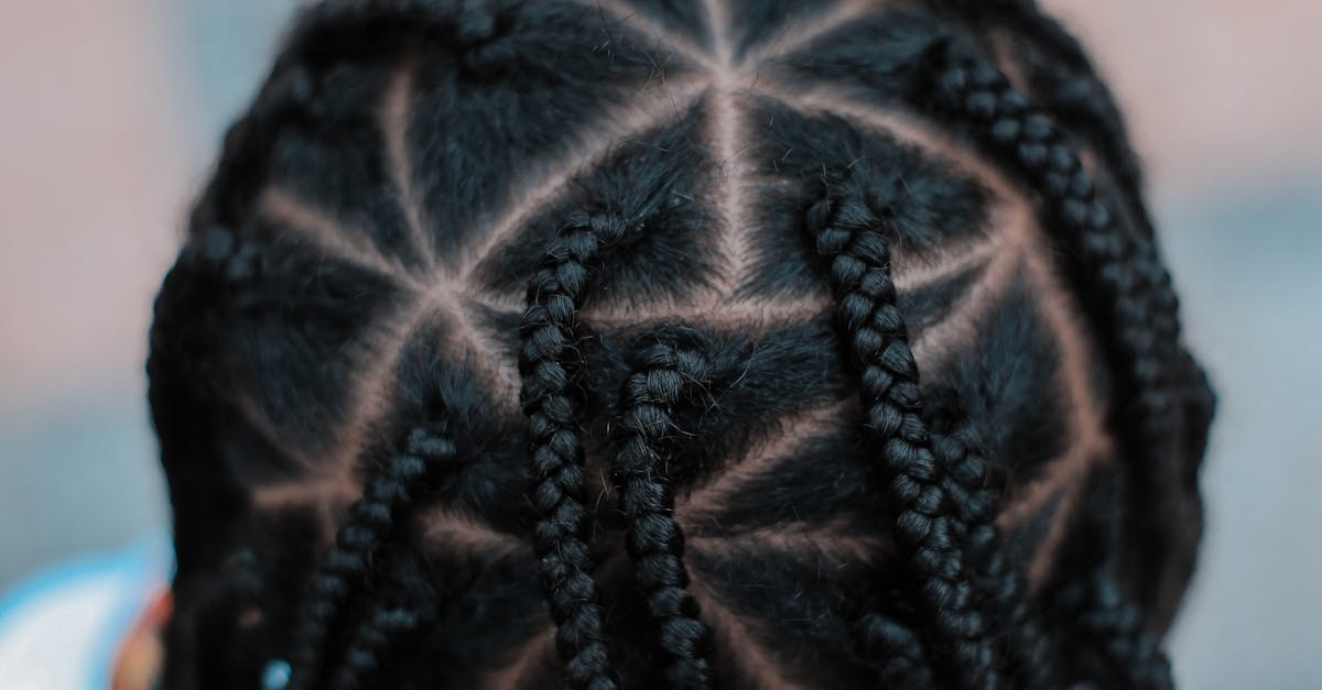 Close-up top view of intricate braided hairstyle on a child, showcasing a unique pattern.