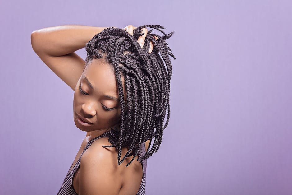 Elegant portrait of a woman showcasing braided hairstyle against a purple background.